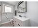 Updated bathroom with a modern vanity, sleek fixtures, and a subway-tiled shower behind glass at 760 Dean Dr, Northglenn, CO 80233