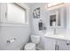 Clean bathroom featuring a white vanity, a toilet, and a window that brings in natural light at 760 Dean Dr, Northglenn, CO 80233
