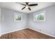This bedroom boasts a modern ceiling fan, beautiful wood floors, and plenty of natural light from the dual windows at 760 Dean Dr, Northglenn, CO 80233