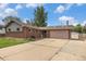 Charming single-story home with a brick facade, a spacious driveway, and a well-maintained front yard at 760 Dean Dr, Northglenn, CO 80233