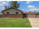 Exterior view of a single-story brick home with a well-maintained lawn and inviting curb appeal at 760 Dean Dr, Northglenn, CO 80233