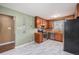 Kitchen with stainless appliances and vintage style cabinets and flooring at 760 Dean Dr, Northglenn, CO 80233