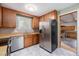 Spacious kitchen featuring modern appliances, wooden cabinets, and a view into another room at 760 Dean Dr, Northglenn, CO 80233