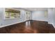 Spacious living room featuring hardwood floors, neutral walls, and a glass door leading to an outdoor area at 760 Dean Dr, Northglenn, CO 80233