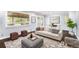 Bright living room featuring modern decor, a comfortable sofa, and a large window providing natural light at 760 Dean Dr, Northglenn, CO 80233