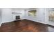 Open living room with dark hardwood floors, a decorative fireplace, and bright window views at 760 Dean Dr, Northglenn, CO 80233