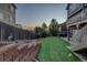 A backyard featuring a lawn with artificial turf, decorative rocks, bird bath and an impressive retaining wall at 1176 Dales Pony Dr, Castle Rock, CO 80104