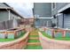 Backyard showcasing garden beds with artificial turf, tiered landscaping and a retaining wall with steps at 1176 Dales Pony Dr, Castle Rock, CO 80104