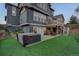 Beautiful backyard featuring a hot tub, upper deck with stairs to yard, well-manicured lawn and lush landscaping at 1176 Dales Pony Dr, Castle Rock, CO 80104
