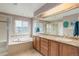 Bright bathroom features dual sinks, granite countertops, soaking tub, and glass enclosed shower at 1176 Dales Pony Dr, Castle Rock, CO 80104