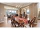 Open-concept dining room flows into the living room, featuring hardwood floors and ample natural light at 1176 Dales Pony Dr, Castle Rock, CO 80104