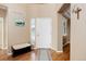 Open entryway with hardwood floors, bench seating, and an adjacent living space at 1176 Dales Pony Dr, Castle Rock, CO 80104