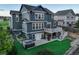 An aerial view of a two-story home showcasing the backyard with a hot tub and deck with stairway at 1176 Dales Pony Dr, Castle Rock, CO 80104