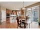 Bright kitchen featuring a breakfast table with access to a deck, wooden cabinets, and modern appliances at 1176 Dales Pony Dr, Castle Rock, CO 80104