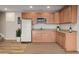 Basement kitchenette features wood cabinets, granite counters, and stainless steel appliances at 1176 Dales Pony Dr, Castle Rock, CO 80104