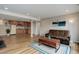 Open-concept basement living area with kitchenette and a cozy seating area with a futon at 1176 Dales Pony Dr, Castle Rock, CO 80104