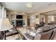 Inviting living room features a fireplace, built-in shelving, and comfortable leather seating, perfect for relaxing at 1176 Dales Pony Dr, Castle Rock, CO 80104
