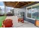 Covered patio with outdoor seating, lush backyard with artificial turf and a hot tub in the background at 1176 Dales Pony Dr, Castle Rock, CO 80104
