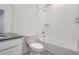 Bright bathroom featuring a shower over tub, tile surround, and modern fixtures at 6562 Arbor Blvd # 4, Thornton, CO 80602