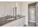 Bathroom featuring double vanity, quartz countertop, large mirrors and a glass shower enclosure at 6562 Arbor Blvd # 4, Thornton, CO 80602