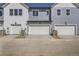 Three-car garages in a row boast modern doors and convenient access with a lengthy driveway at 6562 Arbor Blvd # 4, Thornton, CO 80602