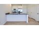 Modern kitchen with stainless steel appliances, light wood floors and a breakfast bar area at 6562 Arbor Blvd # 4, Thornton, CO 80602