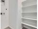Efficient laundry area featuring built-in shelving, neutral paint, and modern fixtures at 6562 Arbor Blvd # 4, Thornton, CO 80602