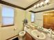 Bathroom showcasing a vanity with a sink, a large mirror, and decorative wall accents at 412 E 131St Ave, Thornton, CO 80241