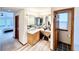 Bathroom featuring a vanity with drawers, a large mirror, and black and white tile flooring at 412 E 131St Ave, Thornton, CO 80241