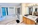 Bright bathroom with a large tub, shower, wood cabinets, and tile flooring at 412 E 131St Ave, Thornton, CO 80241