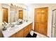 Bathroom featuring a double sink vanity with drawers, a large mirror, and a walk-in shower at 412 E 131St Ave, Thornton, CO 80241