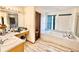 Bathroom featuring a large tub, vanity with drawers, and tile flooring at 412 E 131St Ave, Thornton, CO 80241