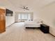 Spacious bedroom with a ceiling fan, television, bay windows, and neutral colored carpet at 412 E 131St Ave, Thornton, CO 80241