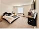 Bedroom featuring neutral colored carpet, a window, and a television at 412 E 131St Ave, Thornton, CO 80241