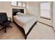 Bedroom featuring neutral colored carpet, a window, and a desk chair at 412 E 131St Ave, Thornton, CO 80241