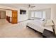 Bedroom featuring a large bay window, a ceiling fan, a television, and neutral colored carpet at 412 E 131St Ave, Thornton, CO 80241