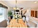 Dining area with a wood table, chandelier, and views into the living room with a fireplace and staircase at 412 E 131St Ave, Thornton, CO 80241