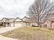 Two-story home featuring a three-car garage and well-maintained landscaping at 412 E 131St Ave, Thornton, CO 80241