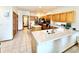 Bright kitchen boasting light wood cabinets, stainless steel appliances, a center island with cooktop, and a large sink area at 412 E 131St Ave, Thornton, CO 80241