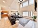 Spacious living room with fireplace, large windows, and view into the dining area at 412 E 131St Ave, Thornton, CO 80241