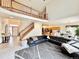Open-concept living room with a staircase, large sectional sofa, and views to kitchen at 412 E 131St Ave, Thornton, CO 80241