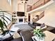 Bright living room with soaring ceilings, fireplace, built-in shelves, and staircase at 412 E 131St Ave, Thornton, CO 80241