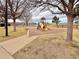 Community playground with slide, climbing structure and safety ground cover at 412 E 131St Ave, Thornton, CO 80241