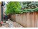 Private backyard with a wooden fence, small rock garden, and patio area, ideal for outdoor relaxation and entertaining at 2138 N Glenarm Pl, Denver, CO 80205
