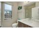 Well-lit bathroom features modern fixtures, a vanity, and a glass-enclosed shower for a sleek and functional space at 2138 N Glenarm Pl, Denver, CO 80205