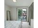 Bright bedroom with a sliding door leading to an outdoor seating area and a full length mirror at 2138 N Glenarm Pl, Denver, CO 80205