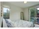 Serene bedroom features a sliding door to a balcony and a large window for abundant natural light at 2138 N Glenarm Pl, Denver, CO 80205