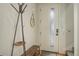 Modern entryway with light walls, a coat rack, a mirror, a bench and a front door with a window at 2138 N Glenarm Pl, Denver, CO 80205