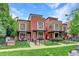 Modern exterior elevation showcasing brick, siding, and a well-maintained front yard with a black metal fence at 2138 N Glenarm Pl, Denver, CO 80205