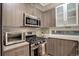 Modern kitchen with stainless steel appliances, wood cabinets, and light countertops at 2138 N Glenarm Pl, Denver, CO 80205